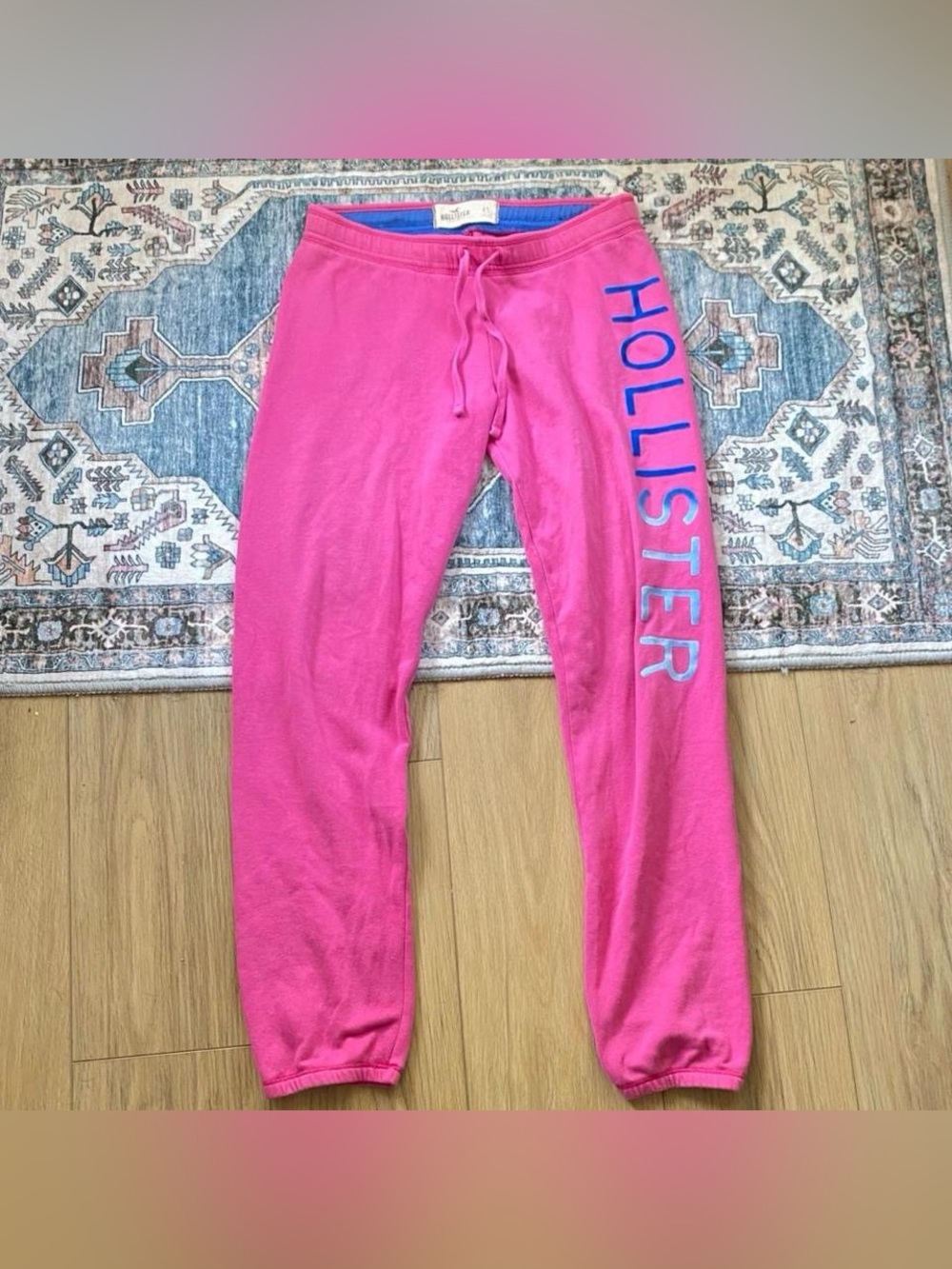 Pink Y2K vintage Hollister sweatpants with blue Hollister text and details